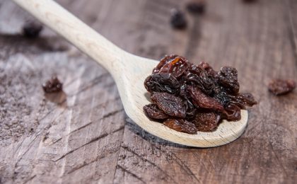 Raisins on a wooden spoon